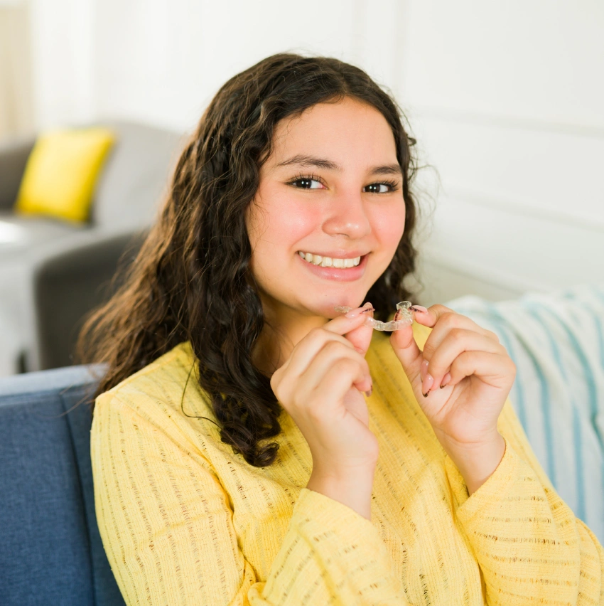 Patient holding Invisalign clear aligners
