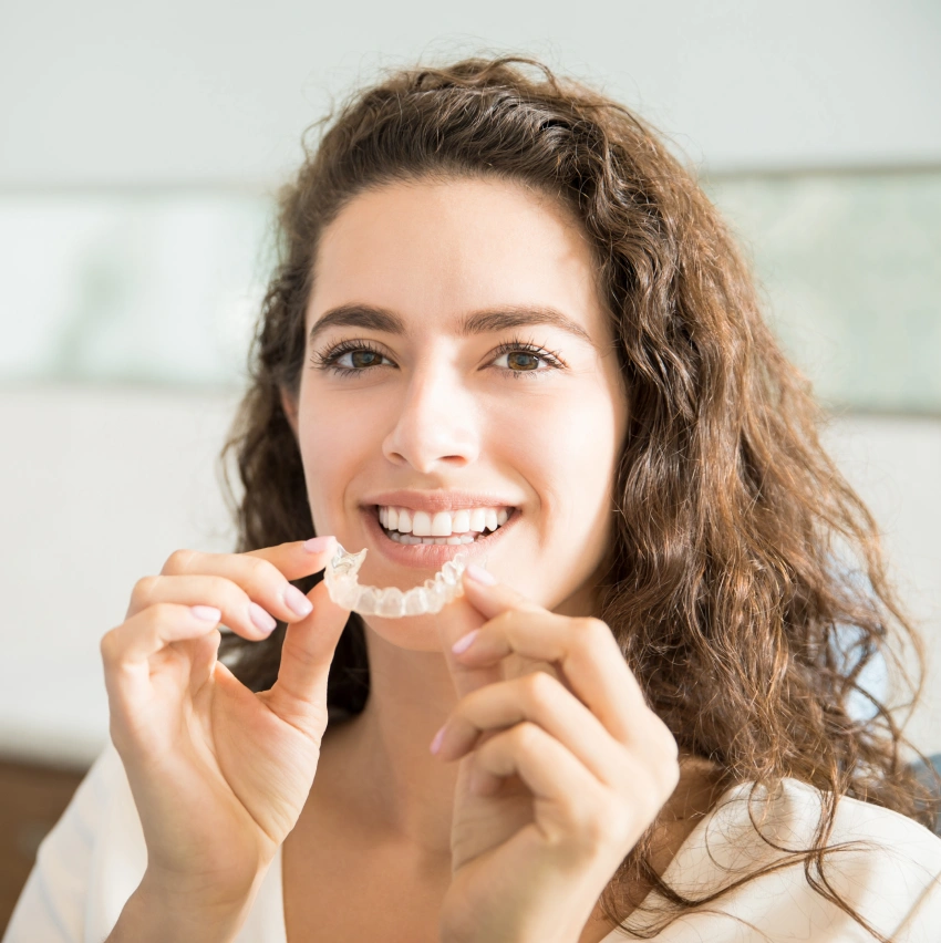 Adult wearing Invisalign clear aligners